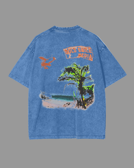 Blue t-shirt with a tropical graphic design on the back, featuring palm trees and a beach scene.